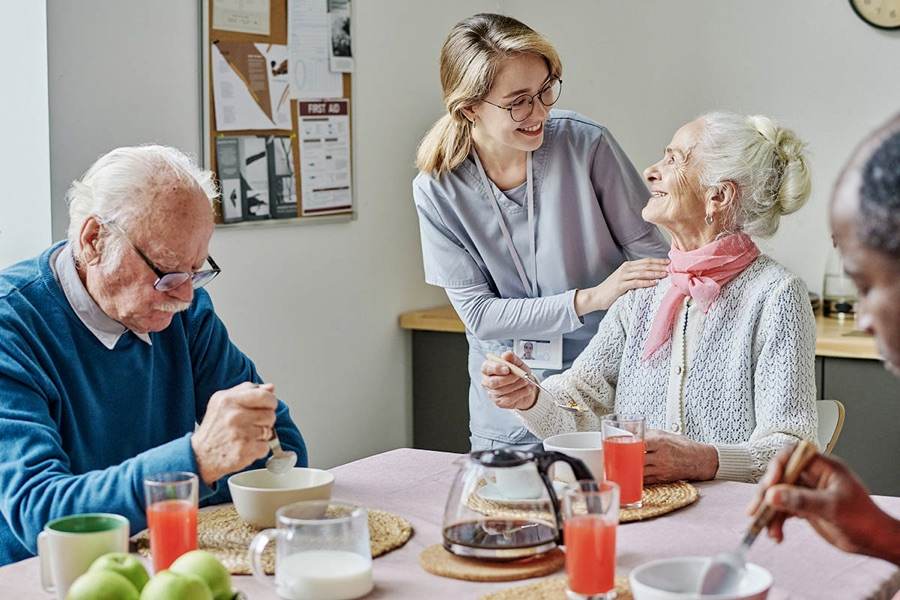 A caregiver spending time with seniors at a community care visit