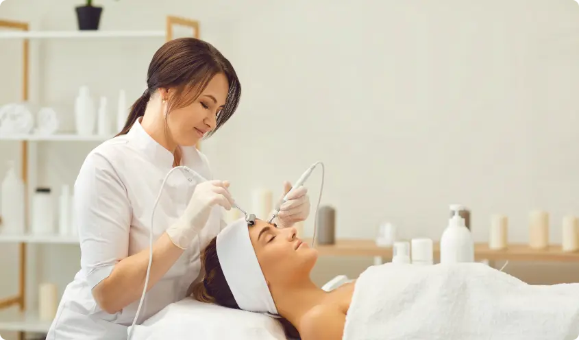 Esthetician performing a facial treatment at a med spa