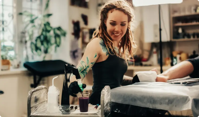 Tattoo artist working in a studio