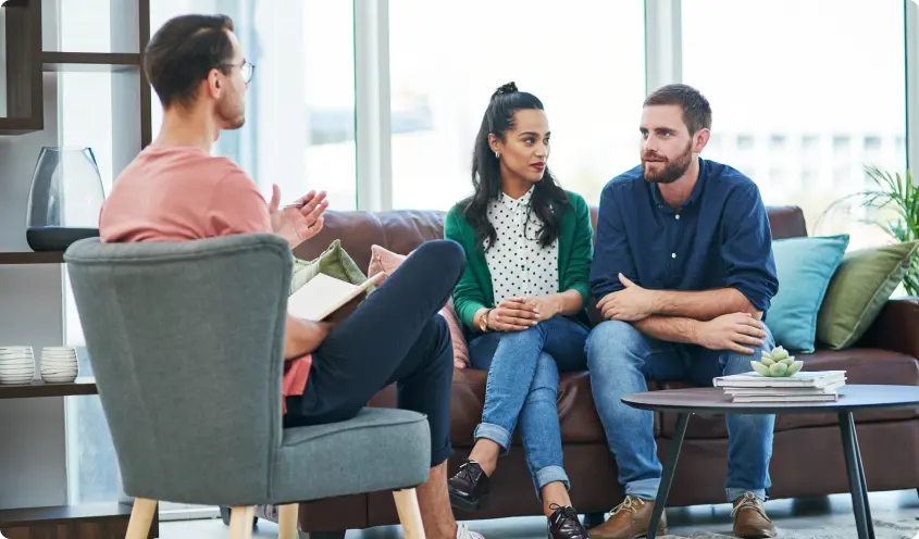Therapist meeting with clients in a bright office